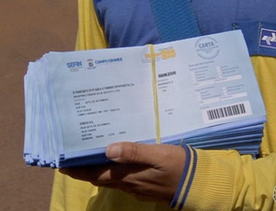 Novos boletos da taxa de lixo começam a ser distribuídos em Campo Grande Prefeitura começa a distribuir os novos boletos da taxa de lixo em Campo Grande (Foto: Reprodução TV Morena)