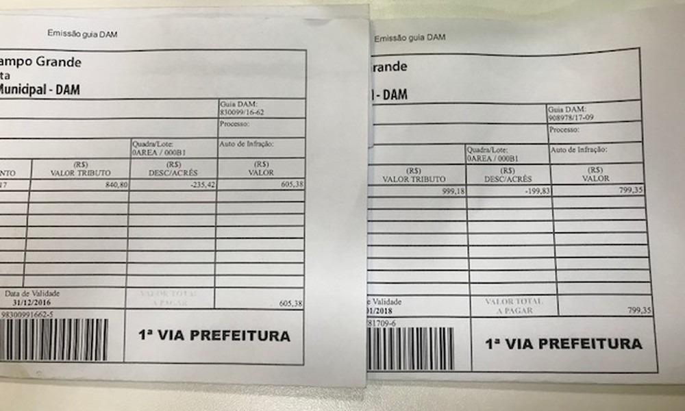 Boleto de cima é referente ao IPTU de Campo Grande (MS) ano de 2017 e o de baixo, de 2018 (Foto: Juliene Katayama)